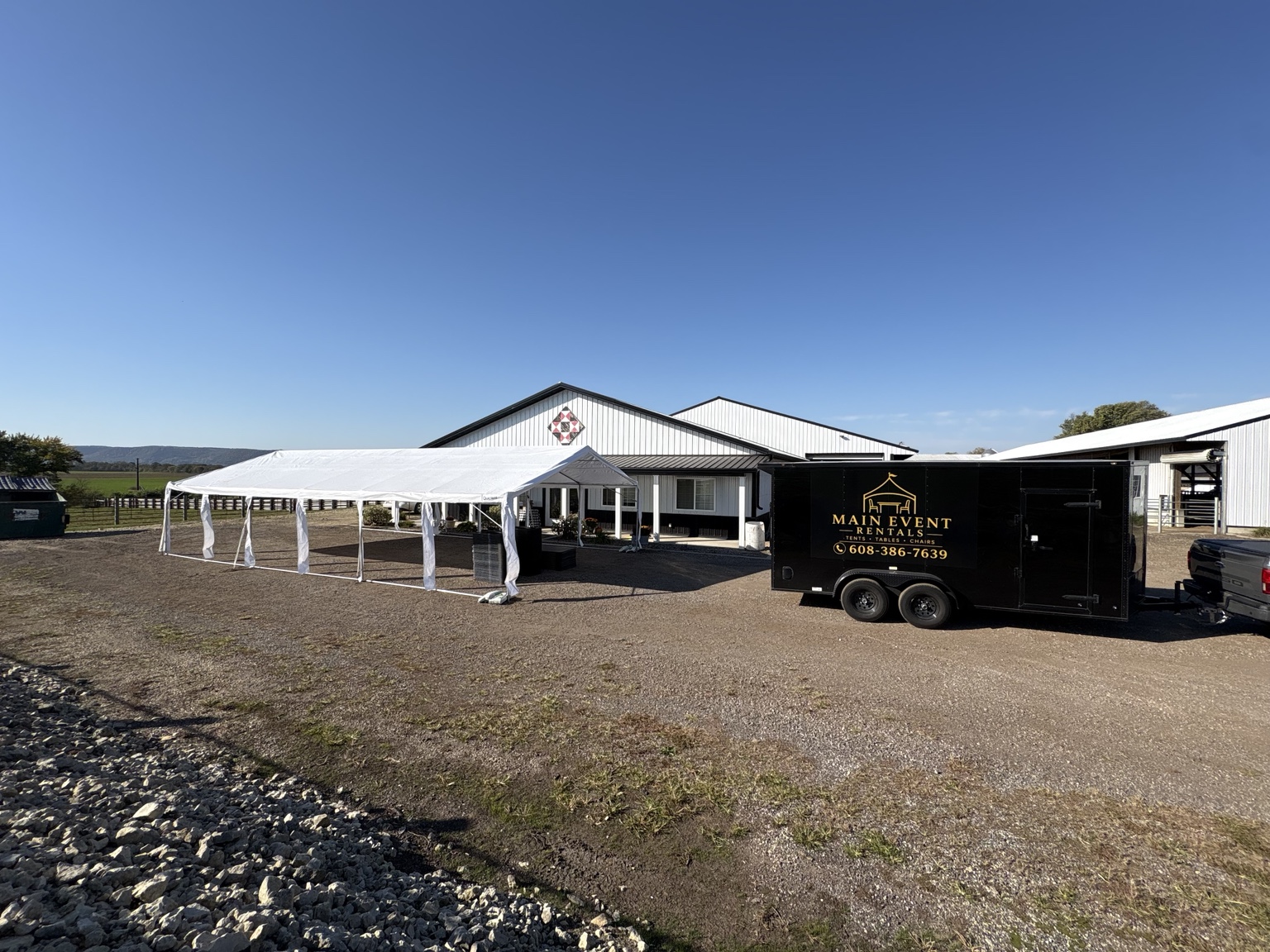 White tents set up beside a building