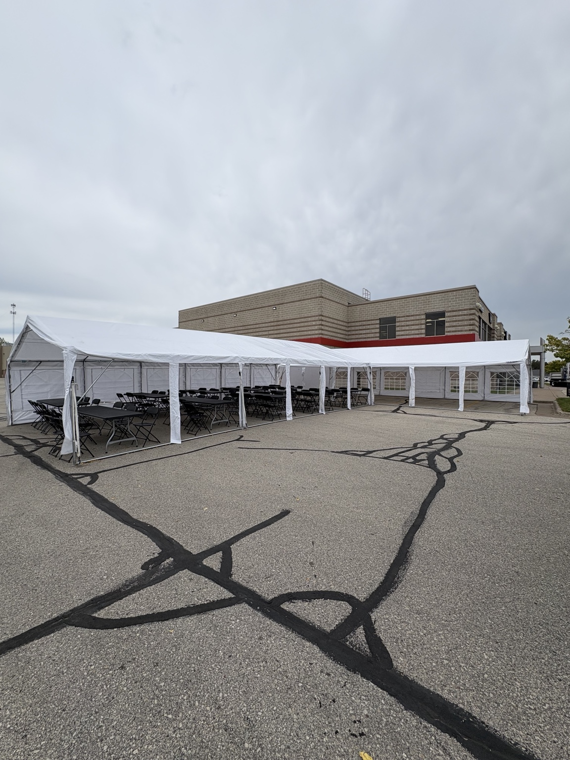 White event tent on a paved lot
