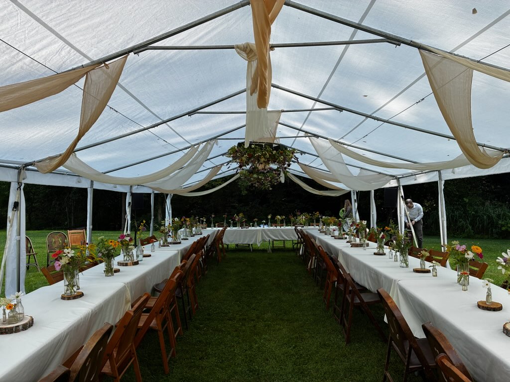 A decorated event tent with long tables