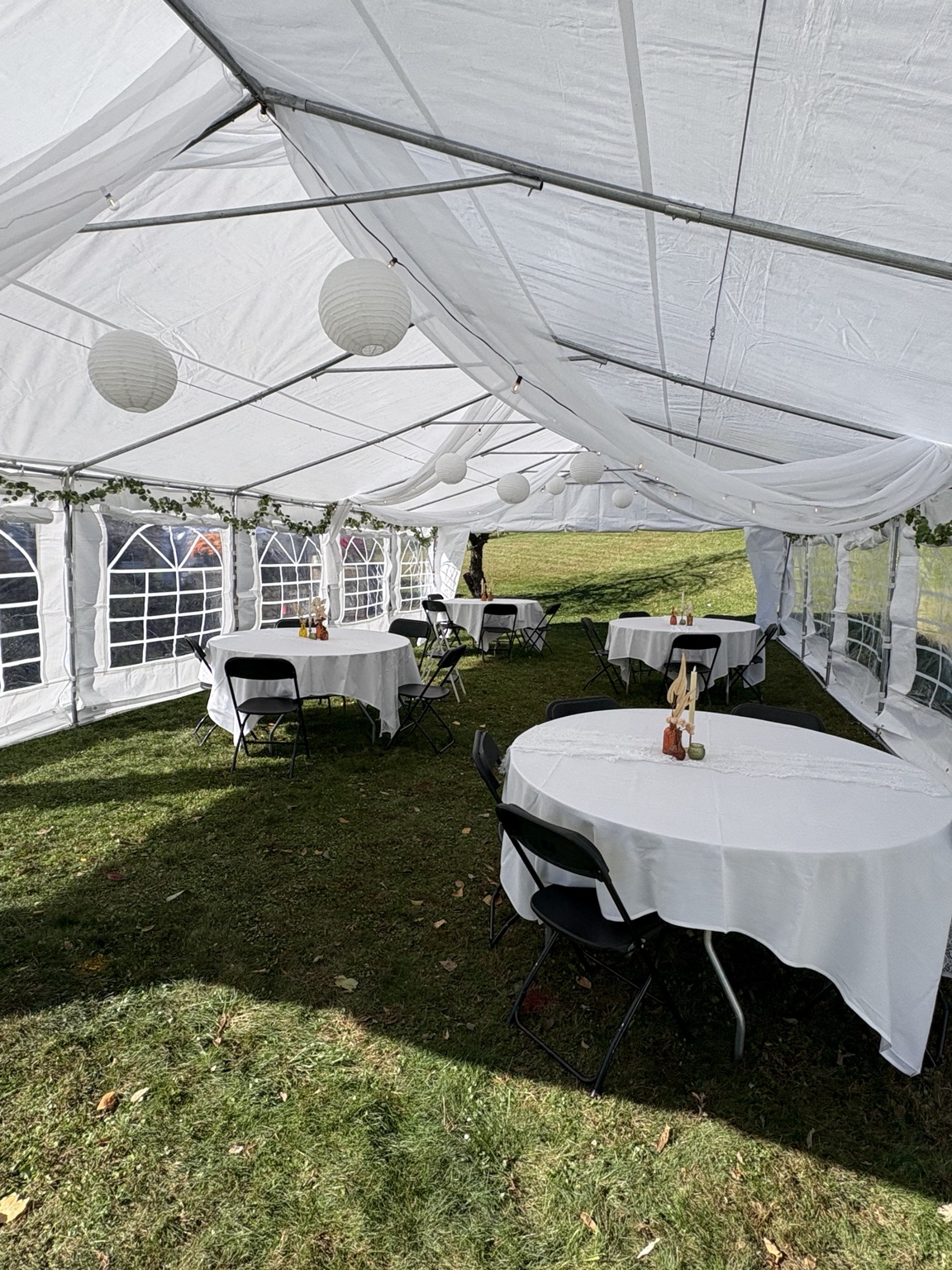 Decorated 20 by 40 frame tent with tables and chairs